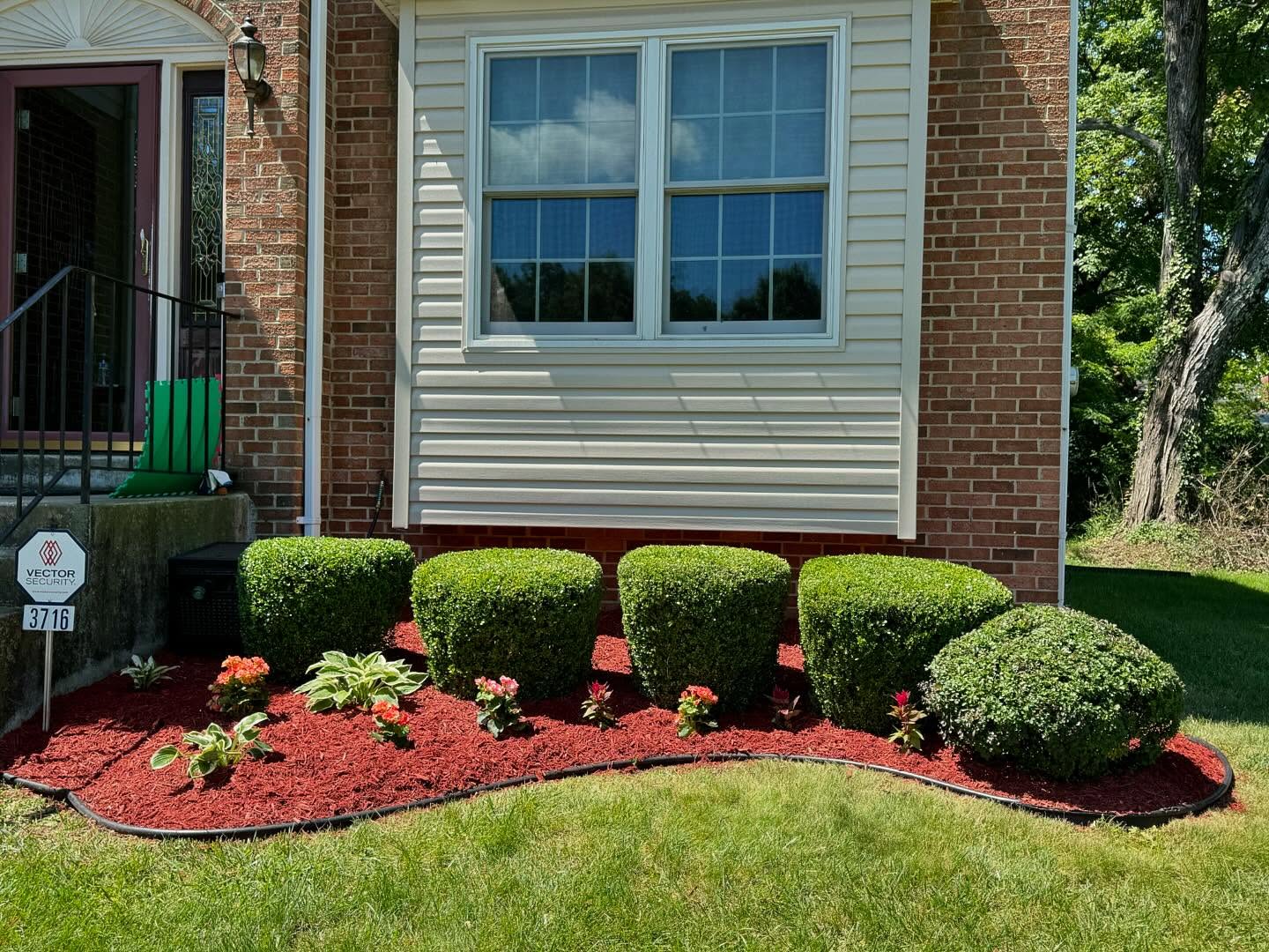 Landscape lighting illuminating storefront gardens at dusk